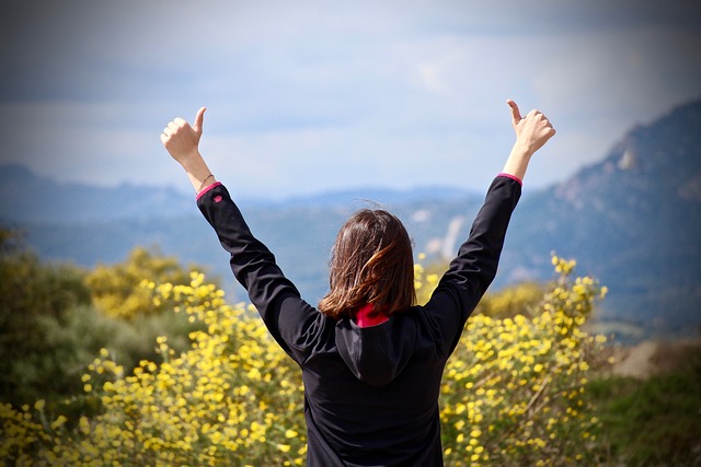 alt= "Woman with thumbs up showing the power of positive affirmations"