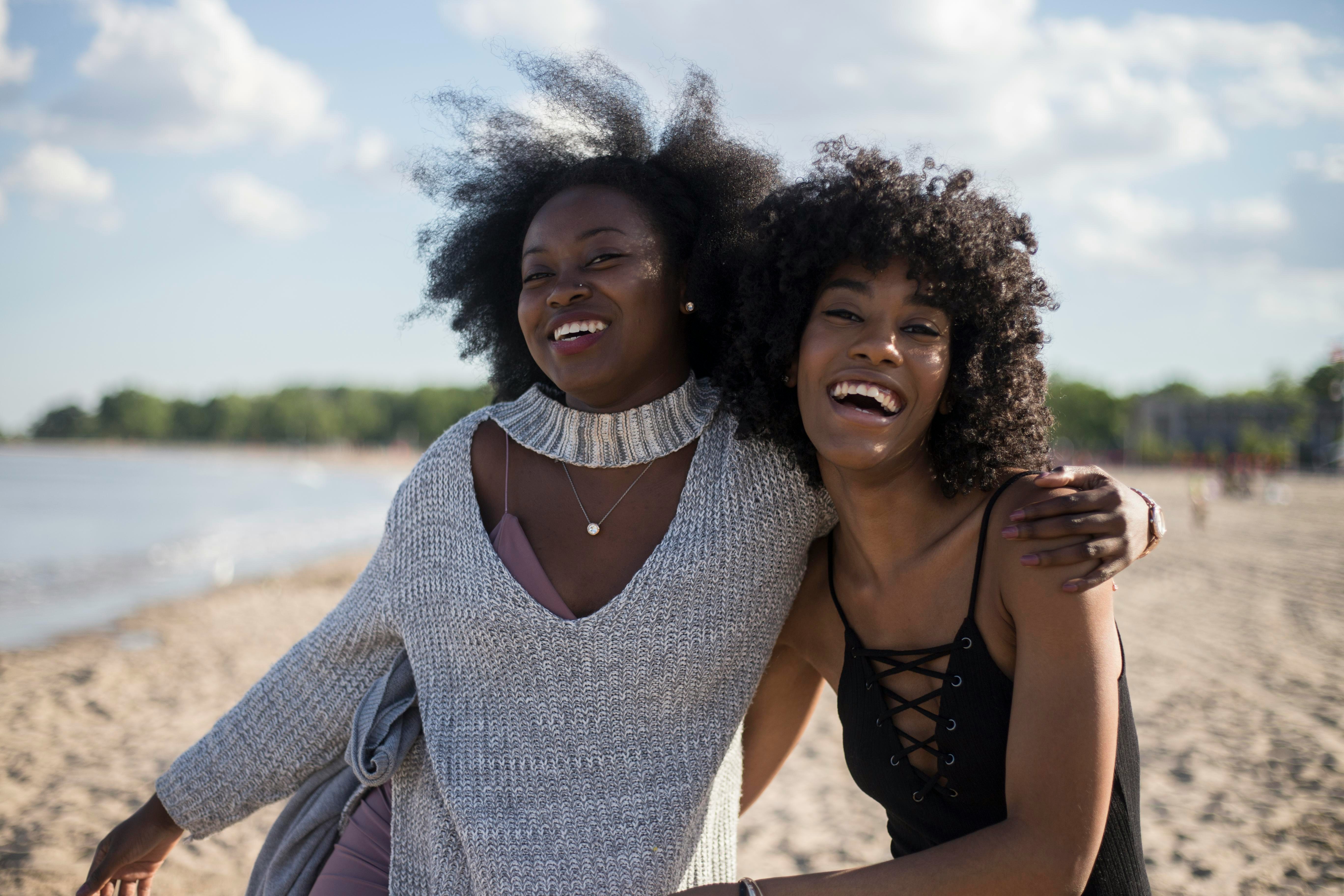 alt= "Two happy women friends"