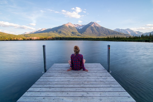 alt= Woman looking at a peaceful scene to create inner peace"